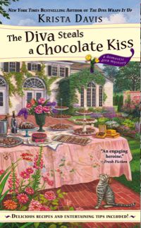 a table with a pink tablecloth in back of a white mansion, the table is covered with all kinds of chocolate yummies